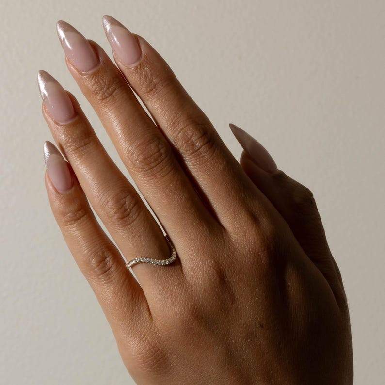 Curved gold wedding band made for stacking with engagement ring
