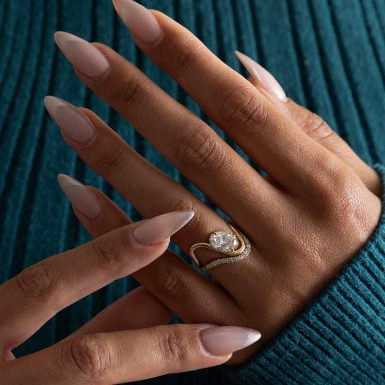 Curved wedding band designed to sit flush with engagement ring
