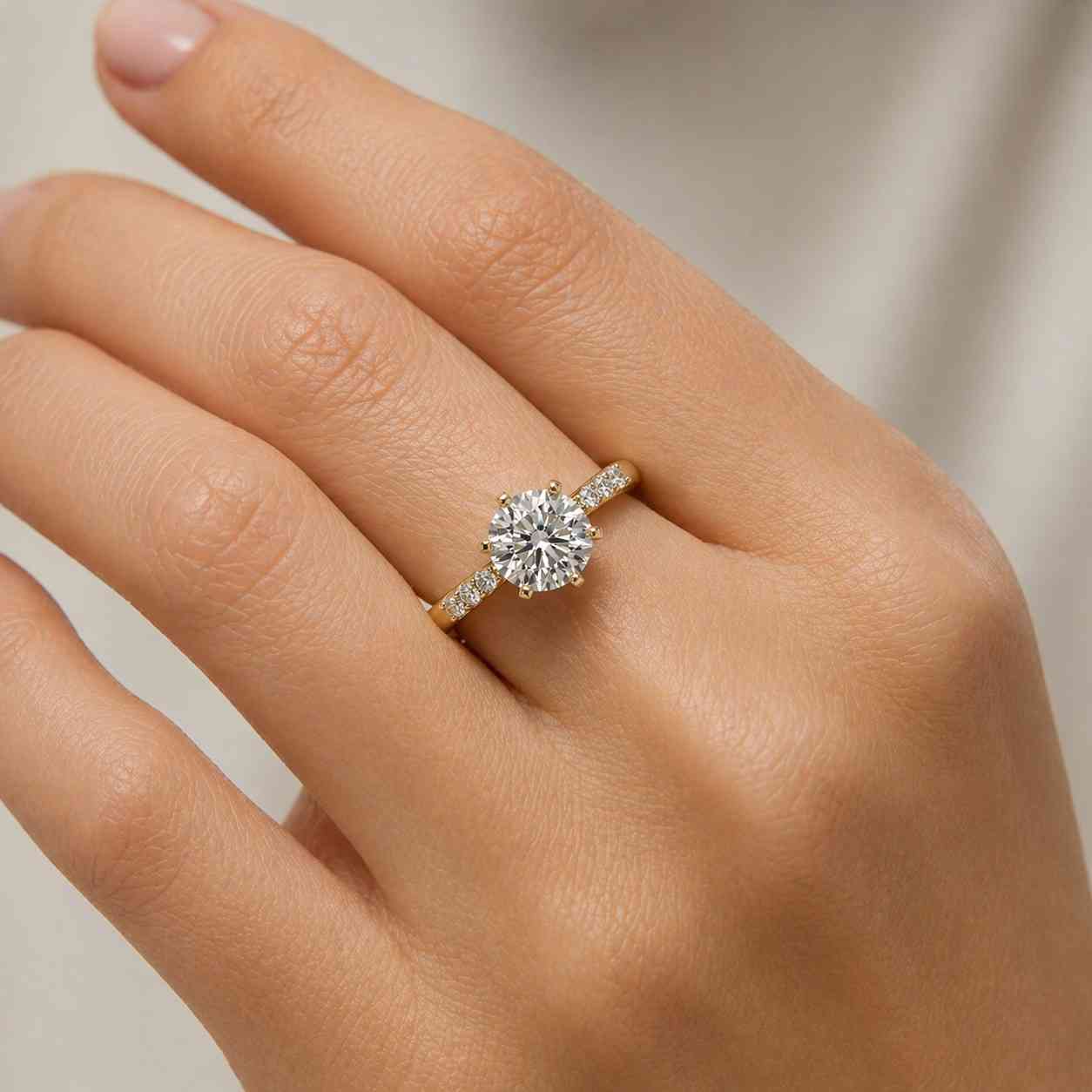 RoundDiamondEngagementRingfeaturingabrightcenterdiamondandsmoothyellowgoldbandwithsidestone