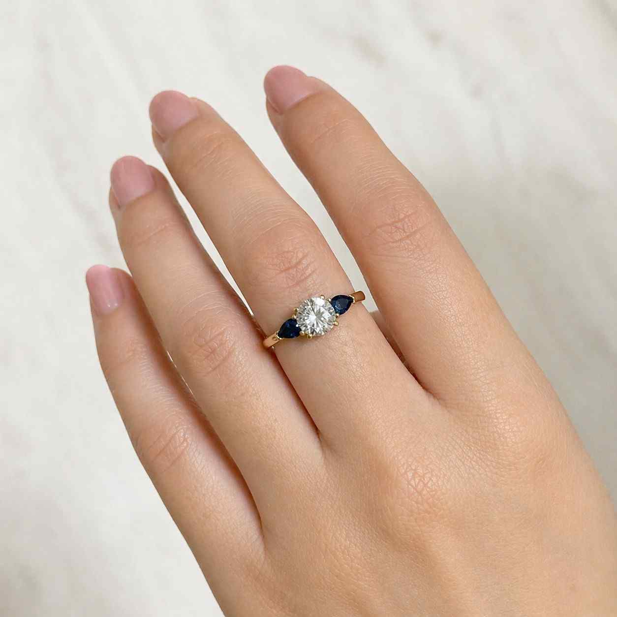 blue sapphire ring round diamond ring pear side stones three stone design engagement jewelry bridal accessory fine ring luxury ring gemstone accessory wedding accessory