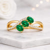 Oval Cut Emerald and Diamond Twisted Infinity Ring