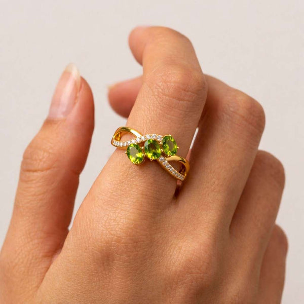 peridot ring green gemstone ring pear cut ring three stone ring infinity ring crossover ring silver ring promise ring women ring statement ring cocktail ring birthstone ring august birthstone ring gemstone jewelry fine jewelry elegant ring unique ring leaf inspired ring